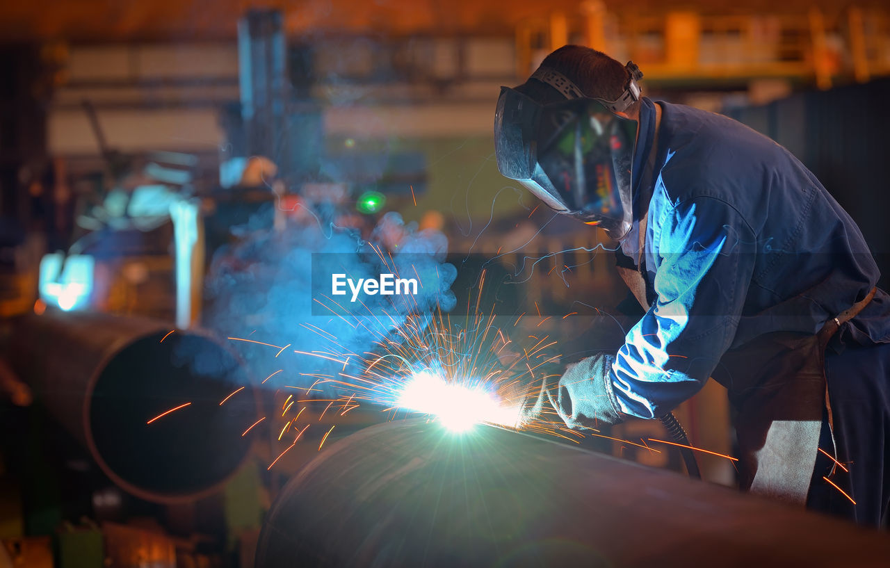 Man working on metal in factory