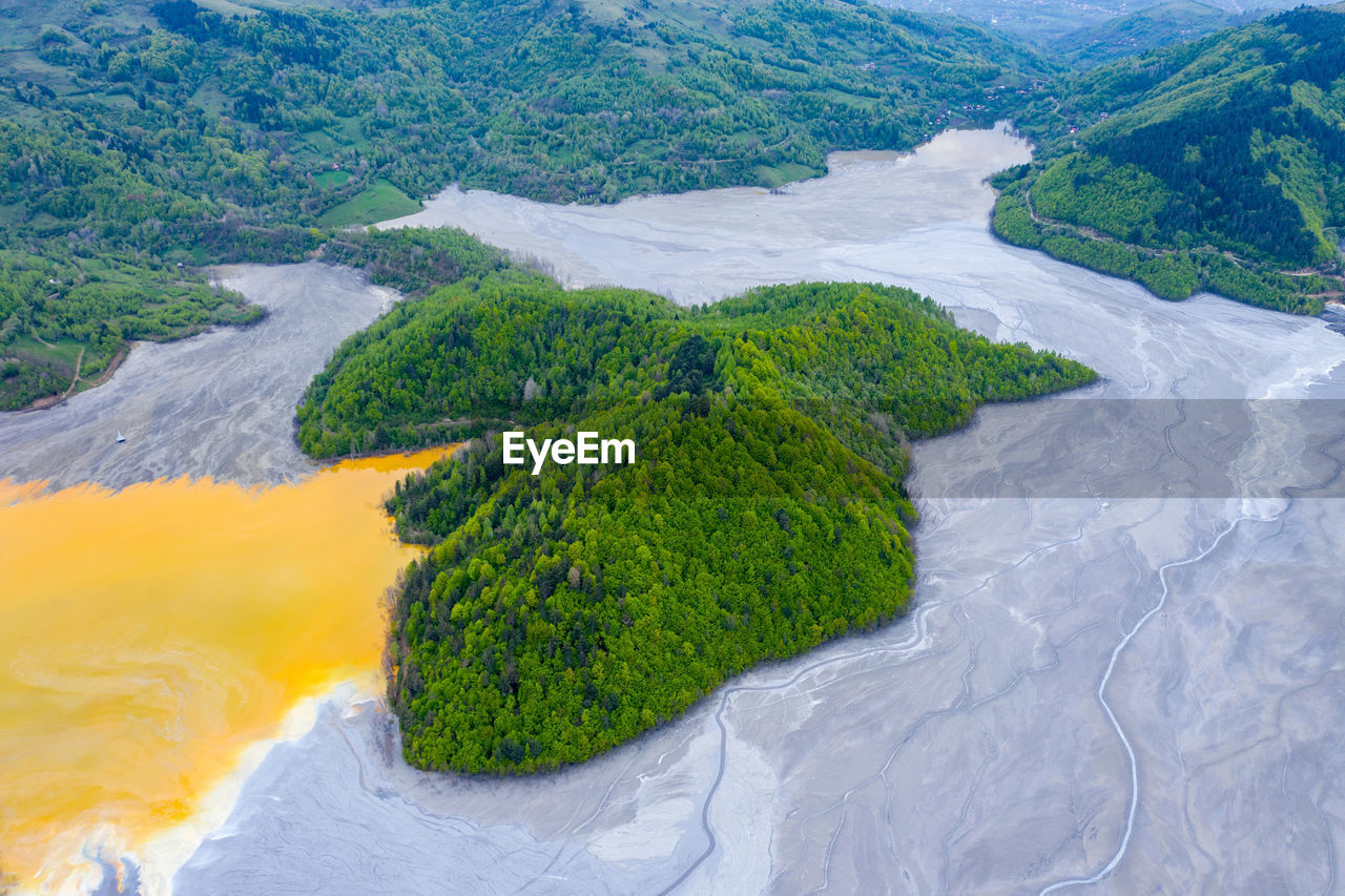 Aerial view of mining settling basin. colorful polluted water  from copper mine geamana, romania