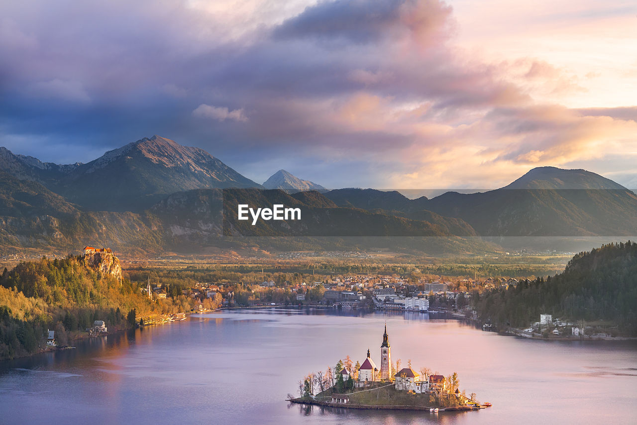 Scenic view of lake by mountains against sky