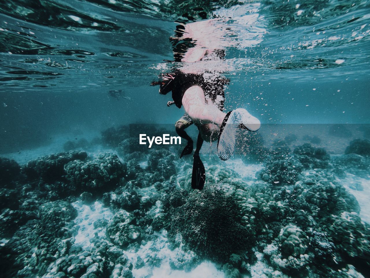 Low section of woman swimming in sea