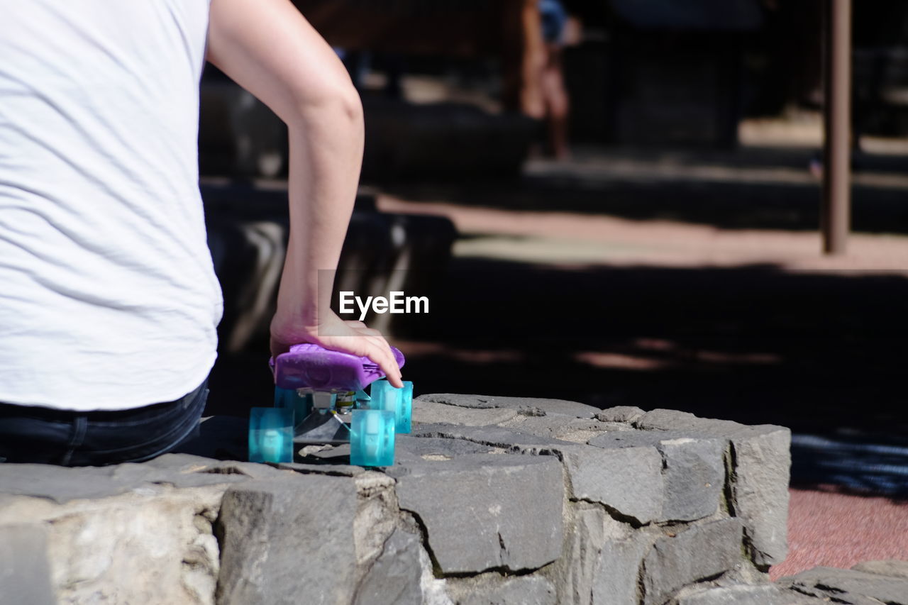 Close-up of person holding a skateboard