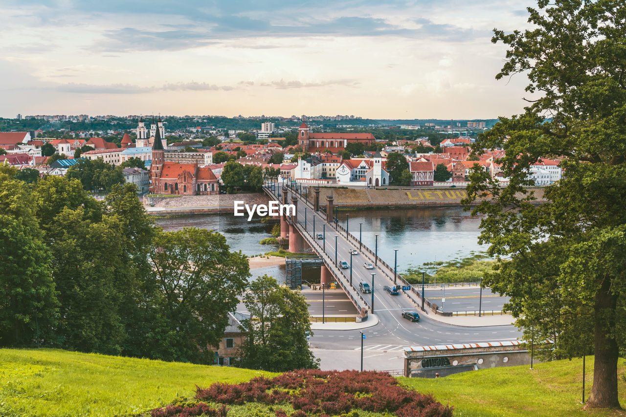 HIGH ANGLE VIEW OF BRIDGE OVER RIVER AND BUILDINGS IN CITY