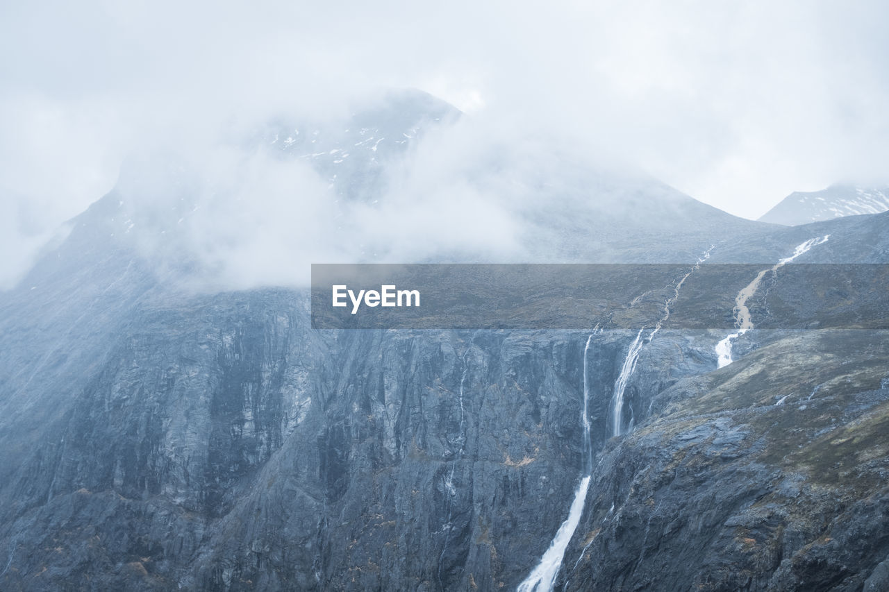 Mountaintop in norway with cloud cover and stigfossen waterfall.
