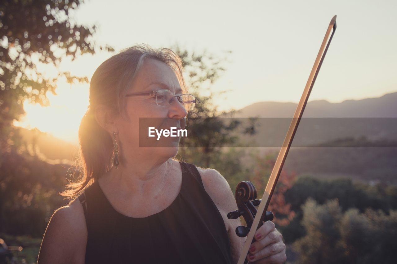 Woman holding a violin bow