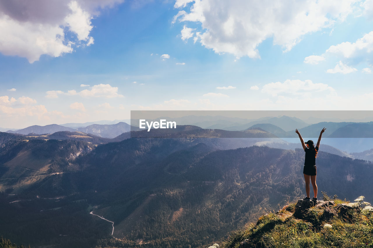 Man standing on mountain against sky