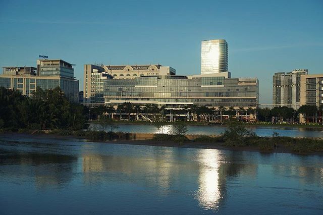 VIEW OF RIVER WITH BUILDINGS IN BACKGROUND AGAINST SKY