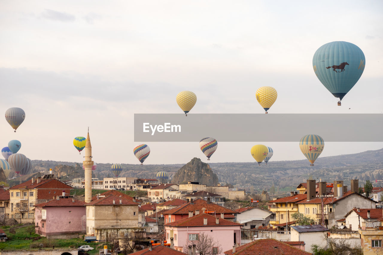 HOT AIR BALLOONS FLYING OVER BUILDINGS