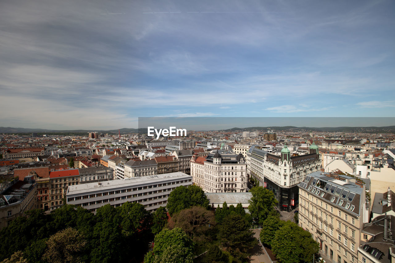 architecture, built structure, building exterior, city, cityscape, sky, building, urban area, high angle view, landmark, nature, skyline, aerial photography, travel destinations, cloud, residential district, crowd, town, horizon, travel, day, downtown, outdoors, metropolitan area, crowded, tree, plant, tourism, city life, bird's-eye view