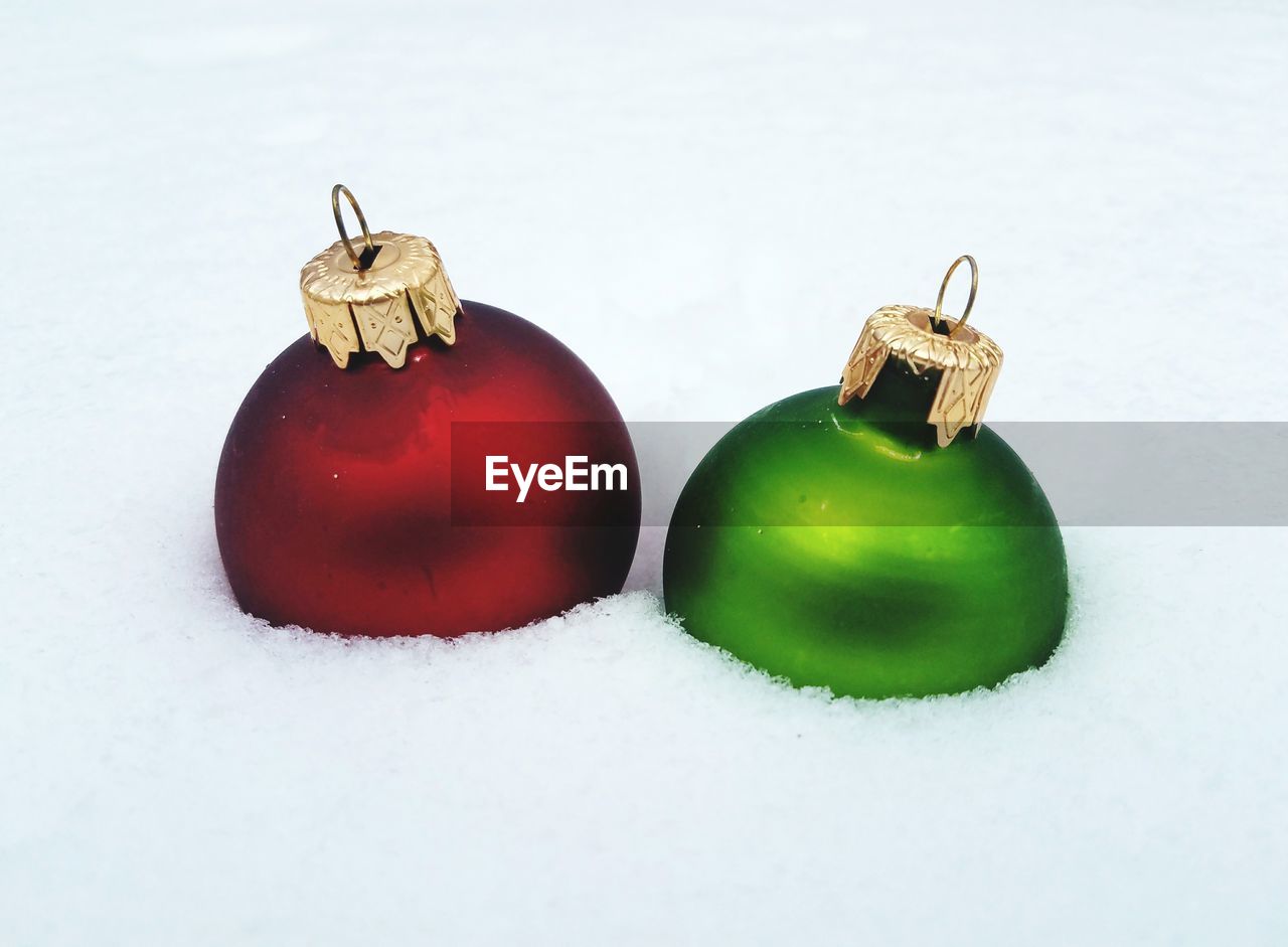 Close-up of baubles on snow