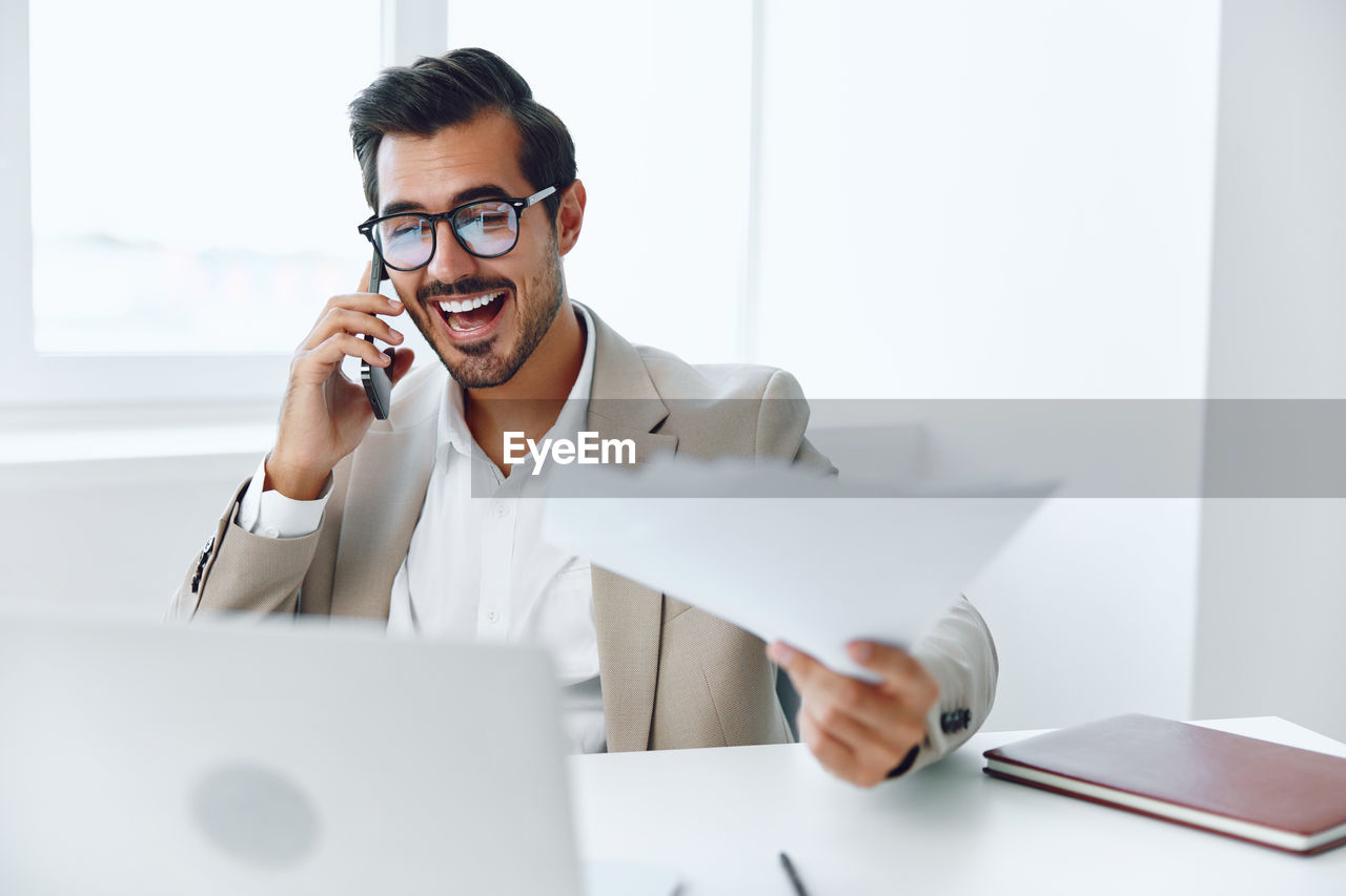 businesswoman using laptop while sitting on table in office