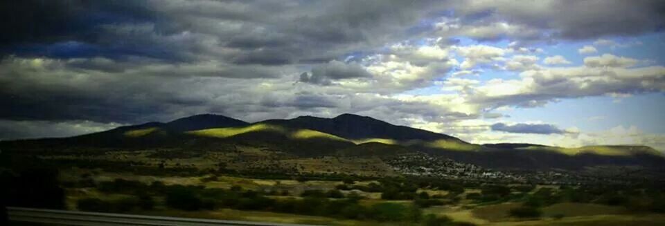 SCENIC VIEW OF MOUNTAINS AGAINST CLOUDY SKY