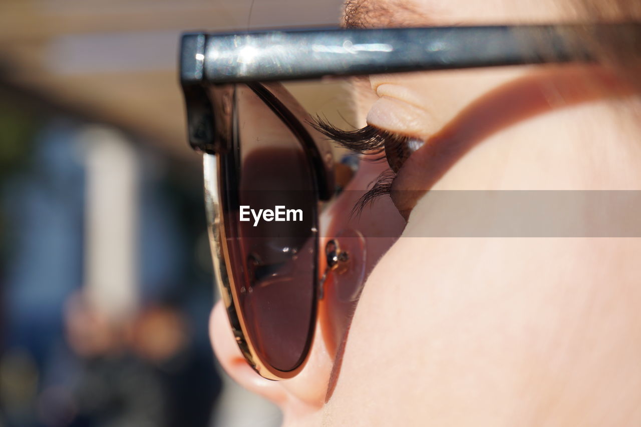 Close-up of woman in sunglasses at home