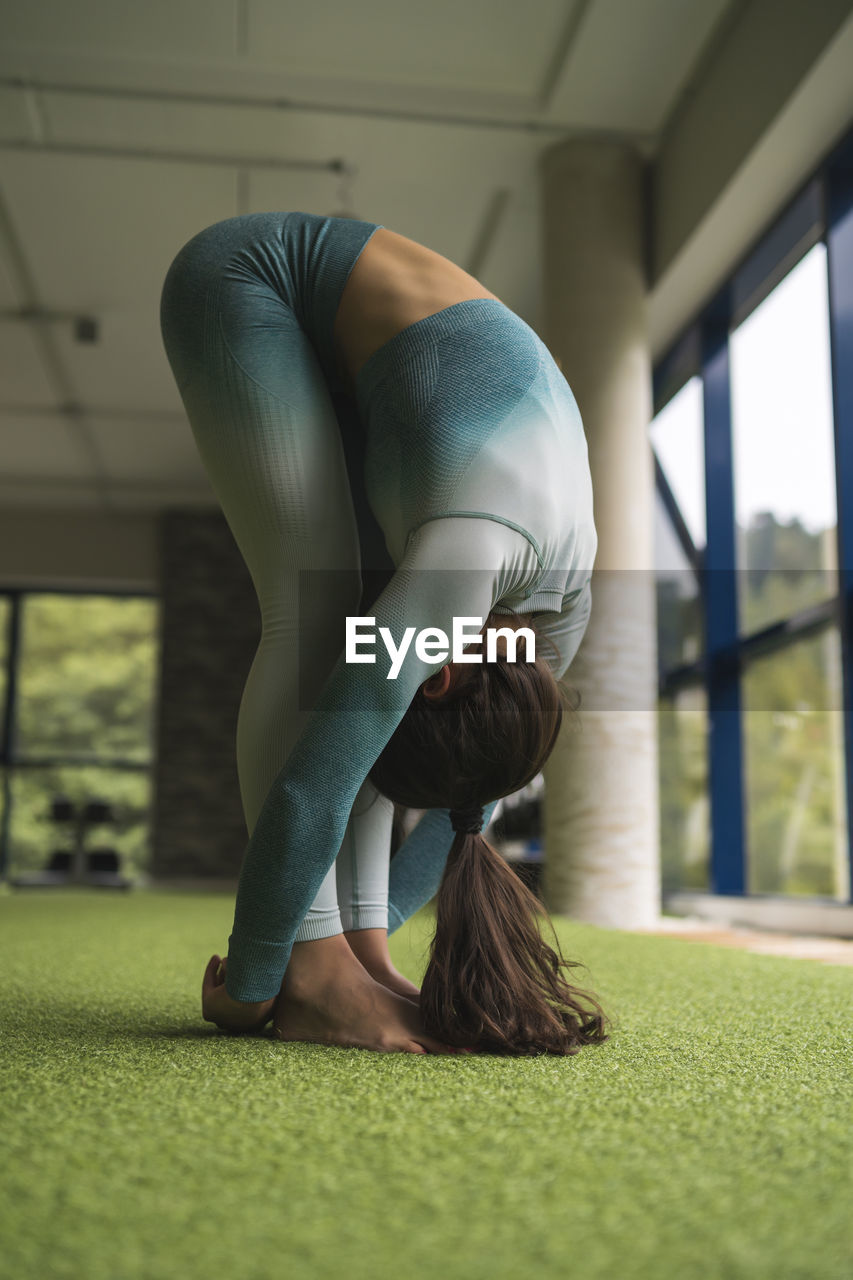 Female athlete practicing yoga at health club