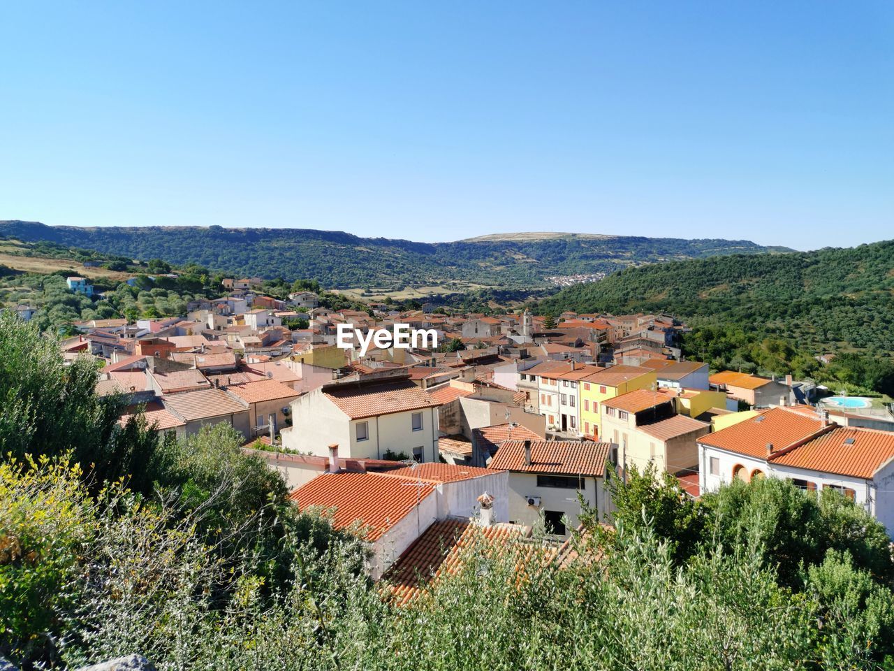 Village of siligo  against hills and clear blue sky