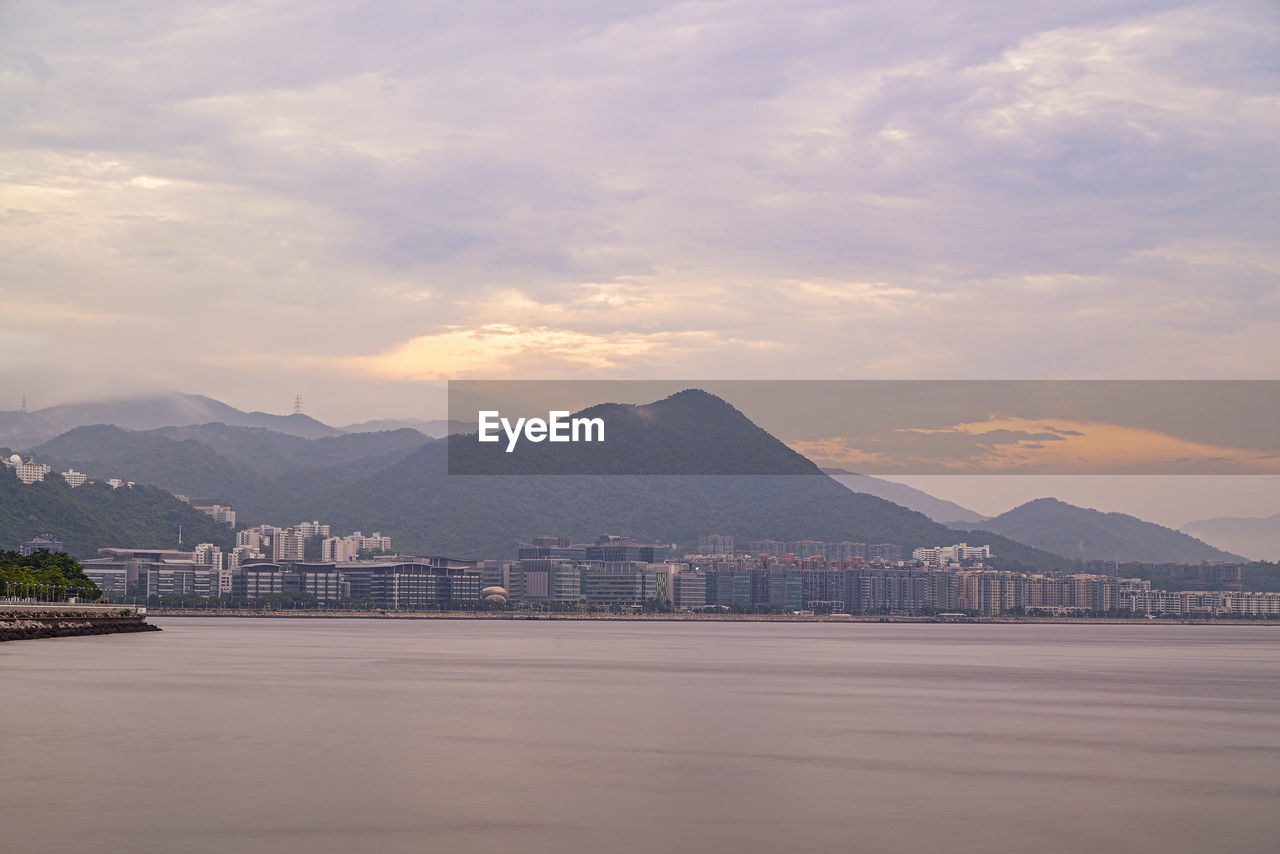 Scenic view of sea and mountains against sky during sunset