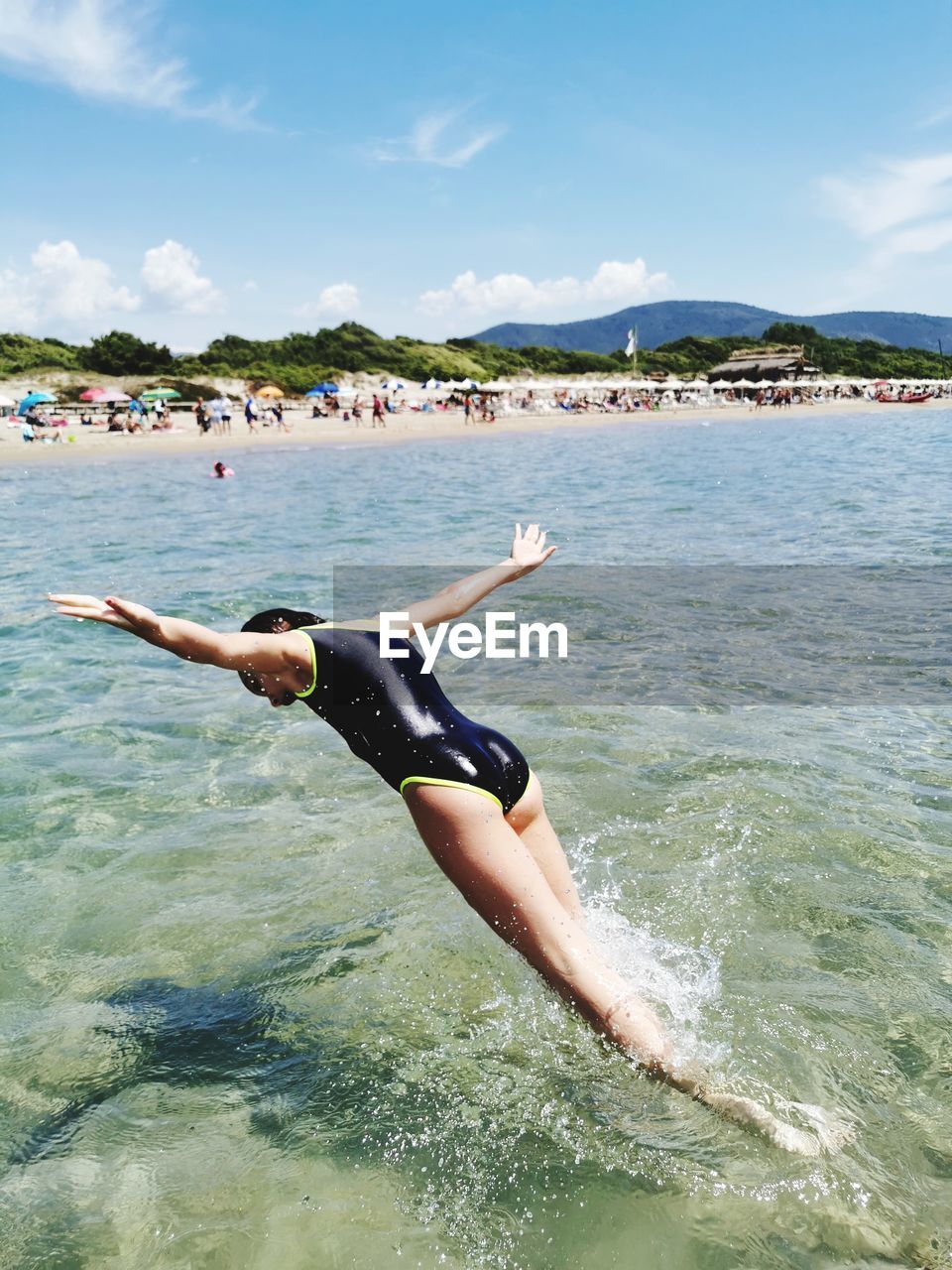 Man surfing in sea against sky