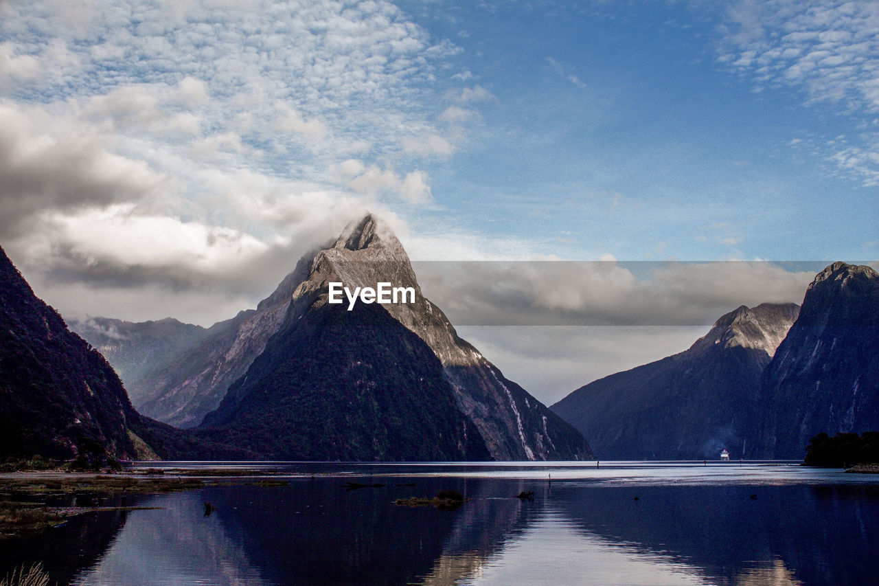 Scenic view of lake and mountains against sky