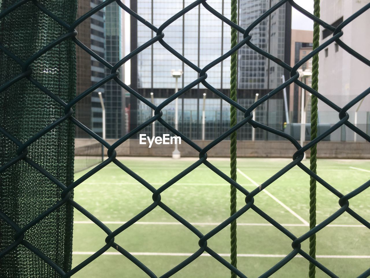 Full frame shot of chainlink fence against playing field