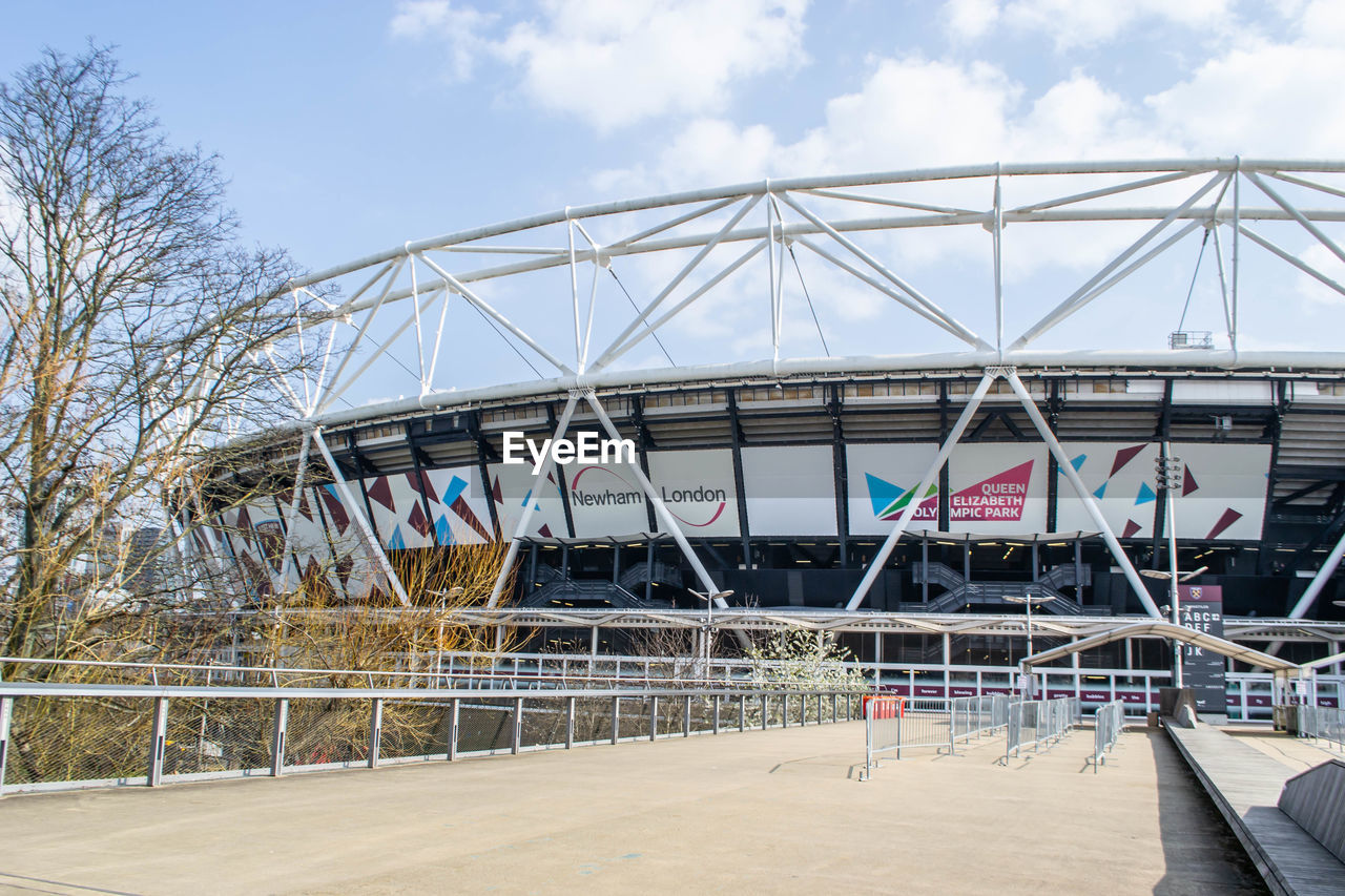 sport venue, architecture, stadium, built structure, arena, sky, nature, day, building exterior, cloud, travel destinations, outdoors, arts culture and entertainment, city, no people, sports, travel, bridge, amusement park, transportation, tourism, water