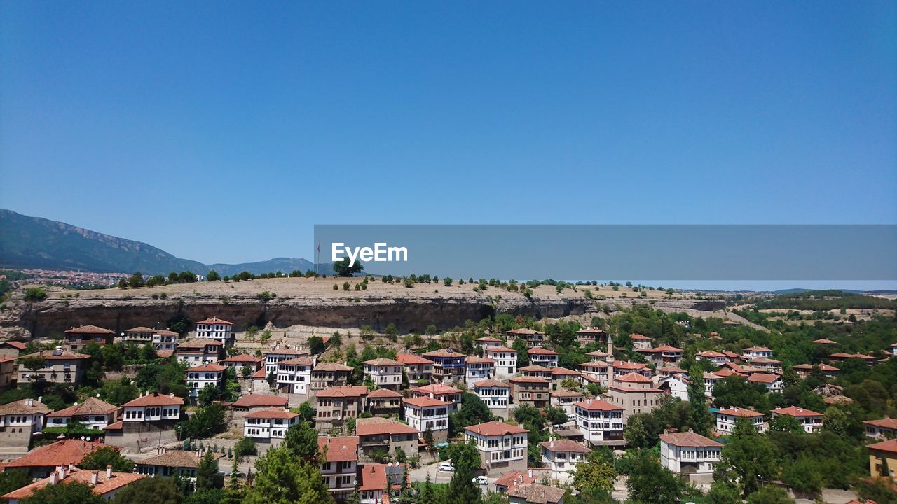 VIEW OF TOWNSCAPE AGAINST BLUE SKY