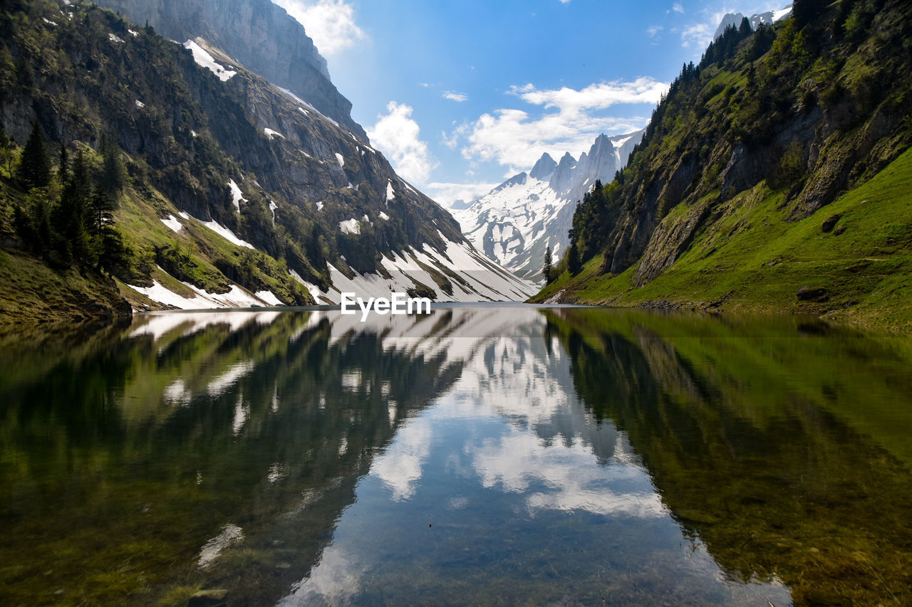 Scenic view of lake and mountains against sky