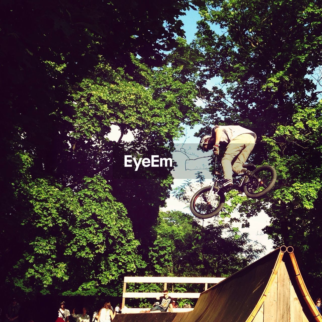 Low angle view of man performing stunt with bicycle