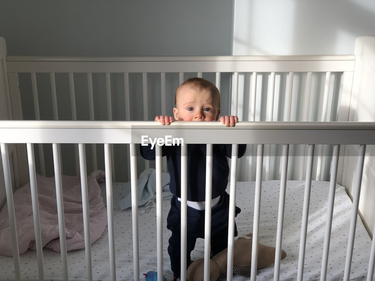 Portrait of boy standing by railing