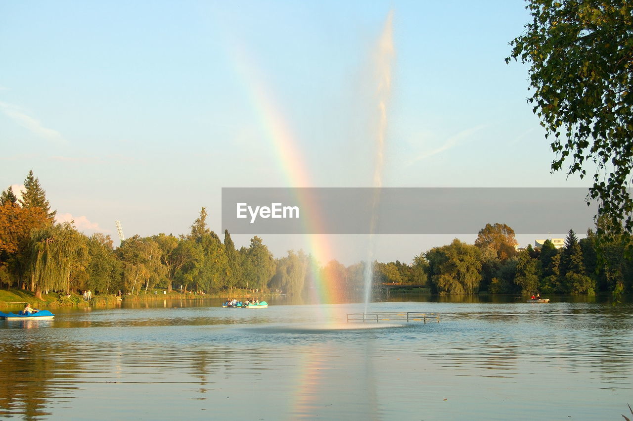 Rainbow over river against sky