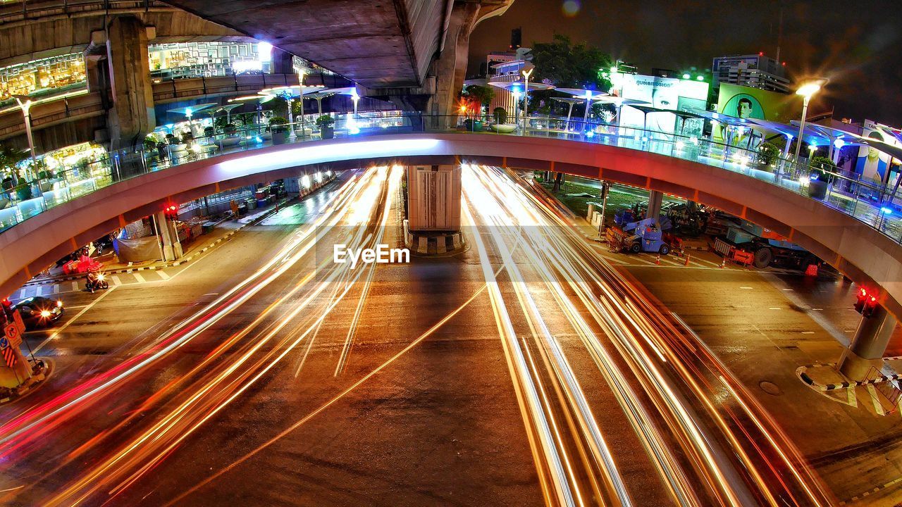 HIGH ANGLE VIEW OF LIGHT TRAILS ON ROAD IN CITY