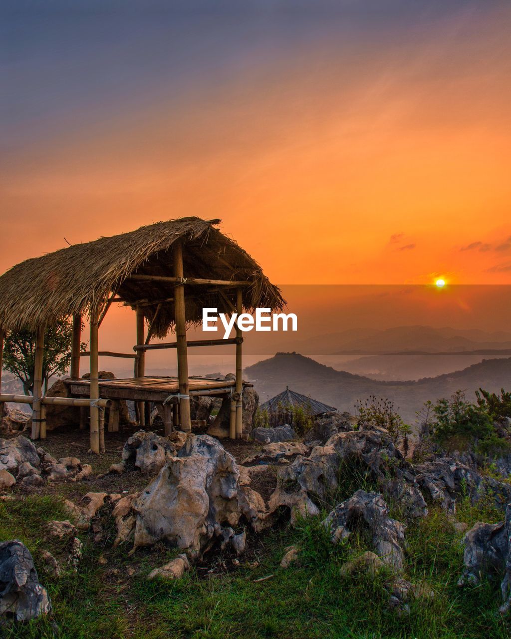 Built structure on land against sky during sunset