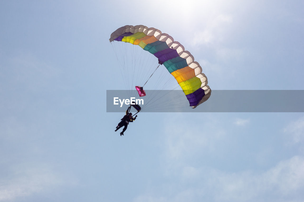 LOW ANGLE VIEW OF PERSON PARAGLIDING