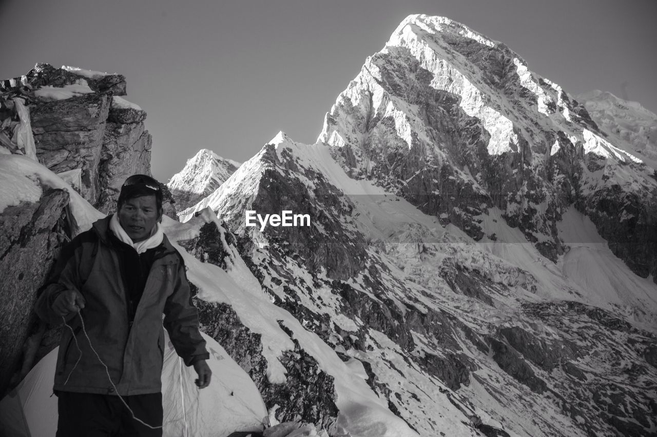 TOURISTS ON SNOW COVERED MOUNTAIN