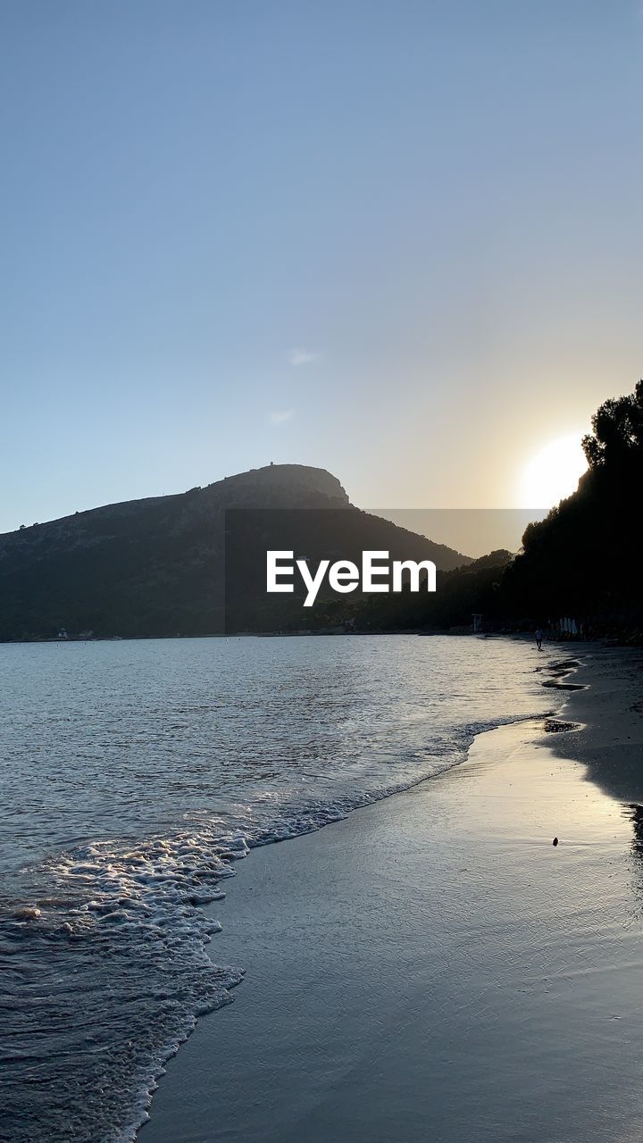 Scenic view of sea against clear sky during sunset