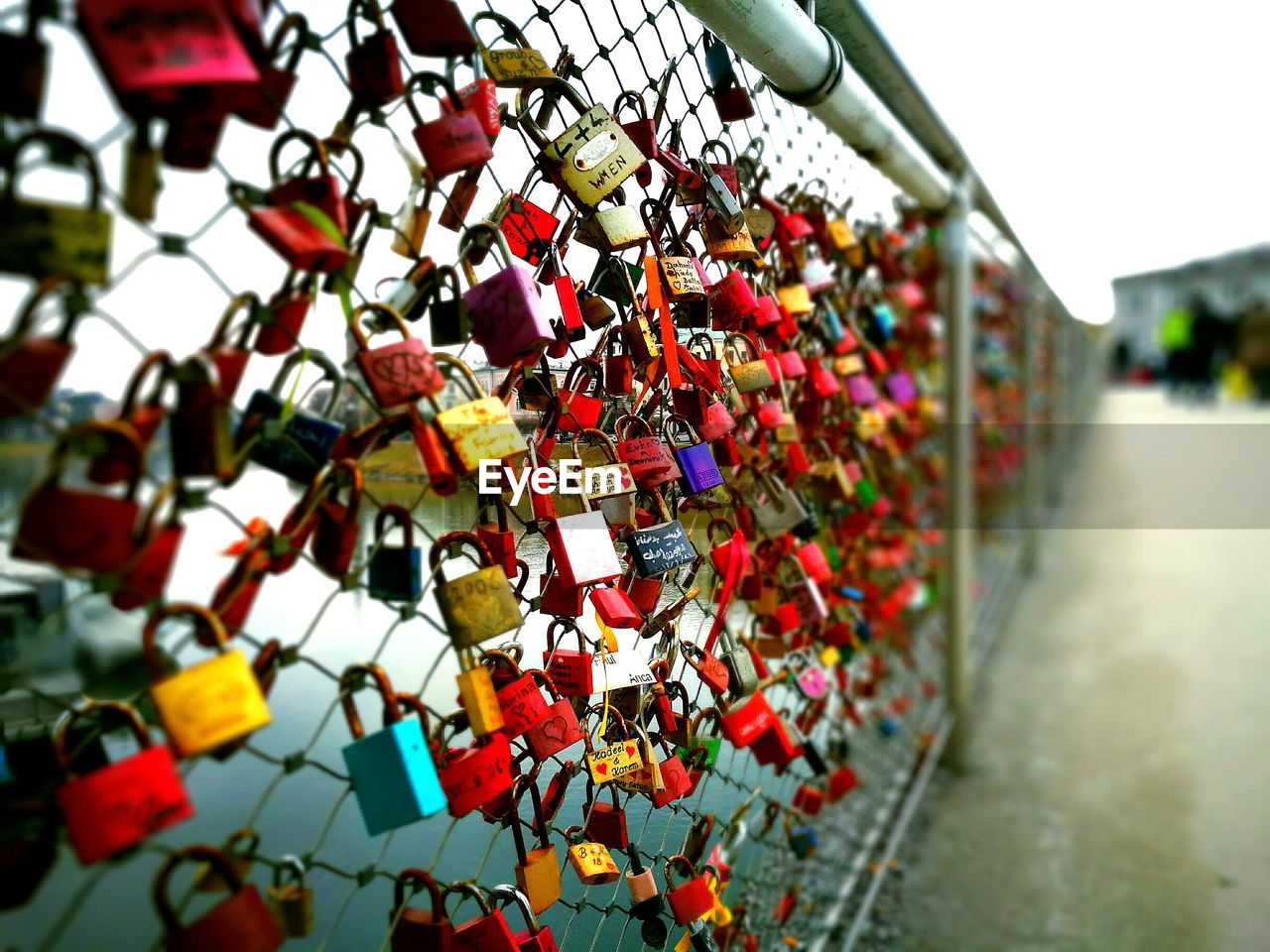 CLOSE-UP OF PADLOCKS ON HEART SHAPE HANGING