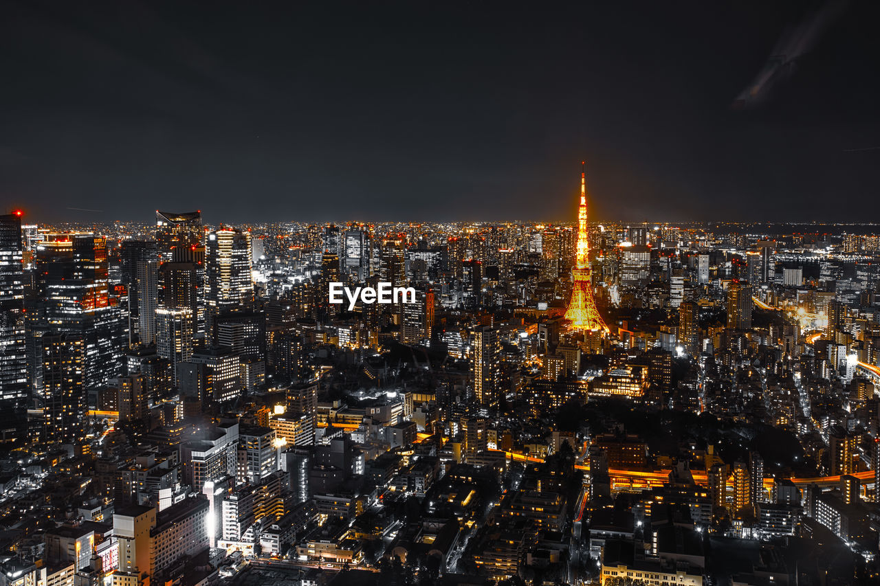 Illuminated cityscape against sky at night