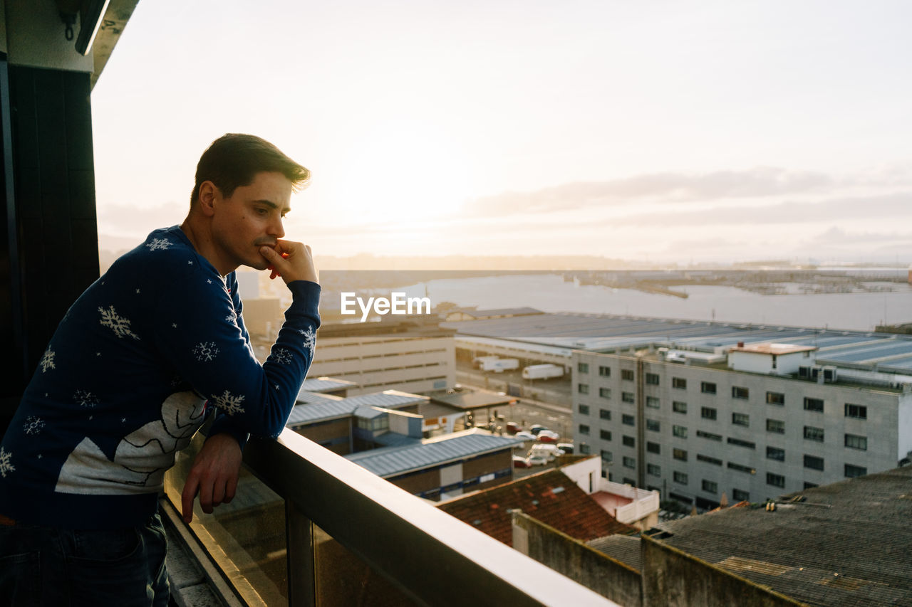 side view of man using mobile phone