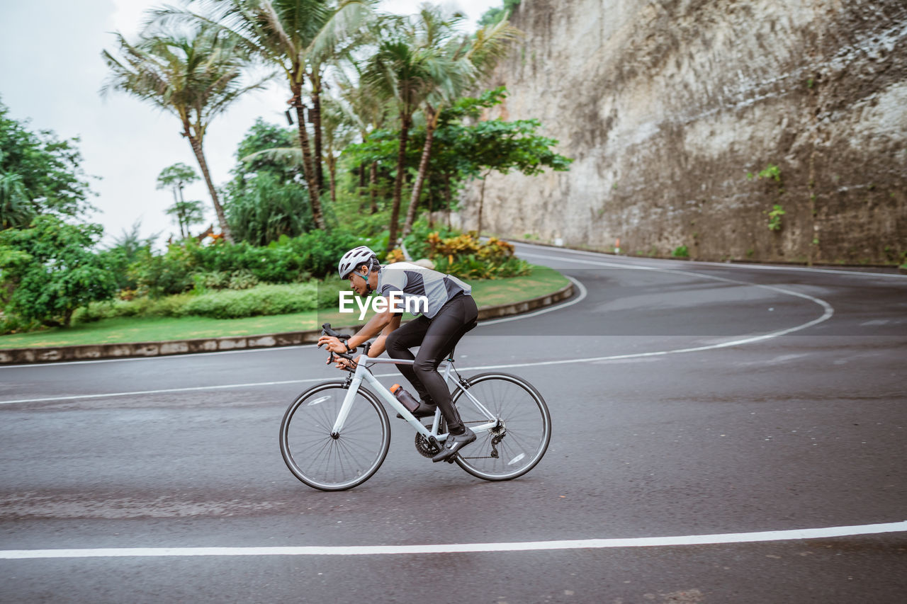 Man riding bicycle on road