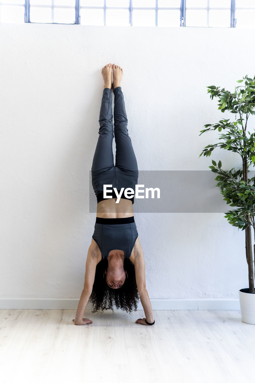 Woman doing handstand at home