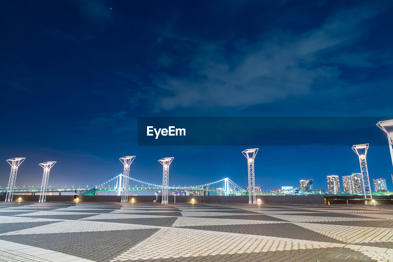 ILLUMINATED BRIDGE AGAINST BLUE SKY