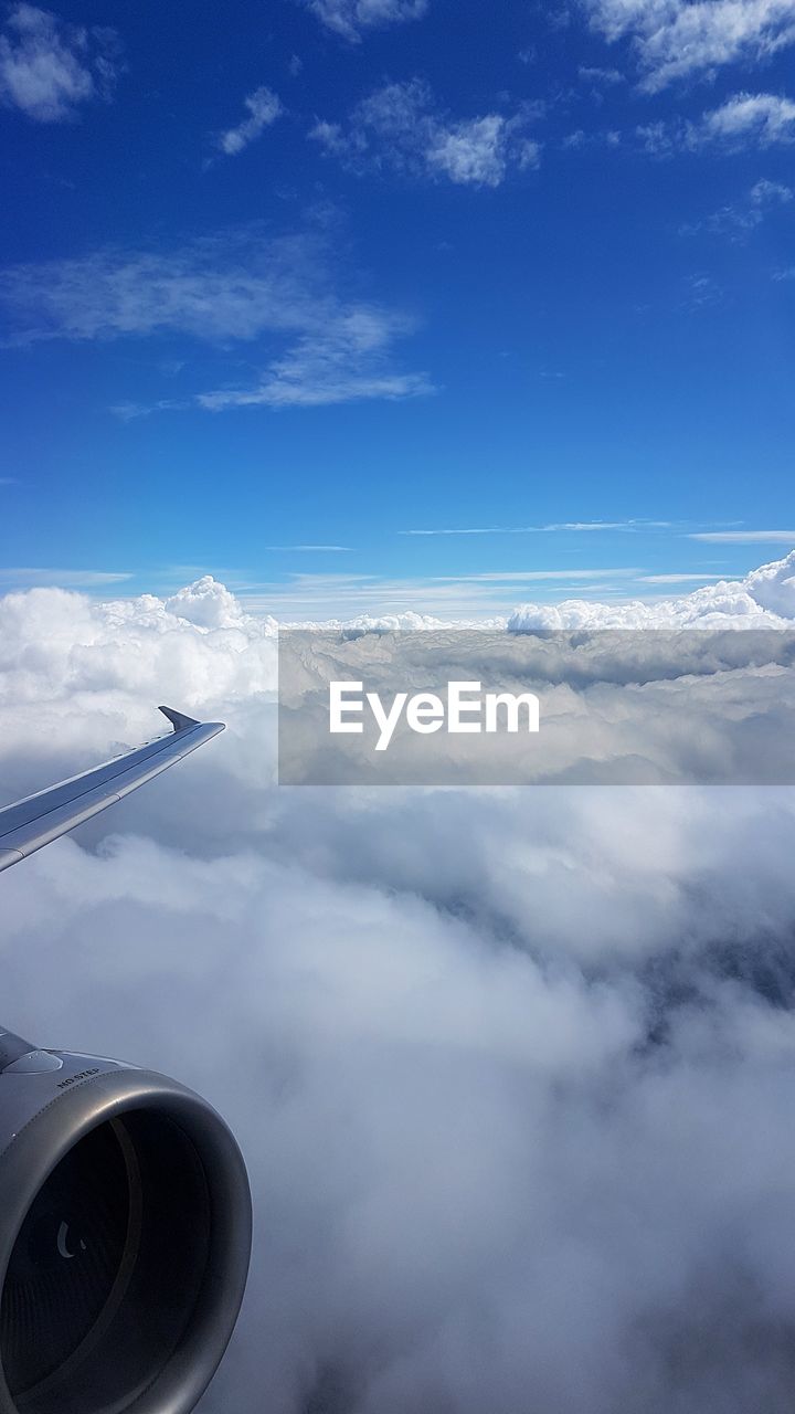 AERIAL VIEW OF CLOUDS OVER AIRPLANE WING