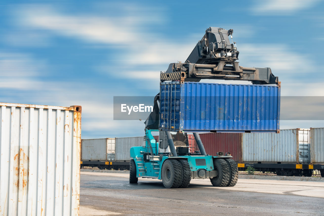 Vehicle lifting containers at commercial dock