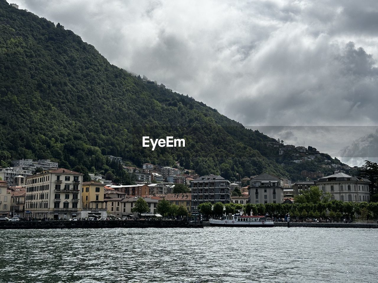 scenic view of sea by buildings against sky
