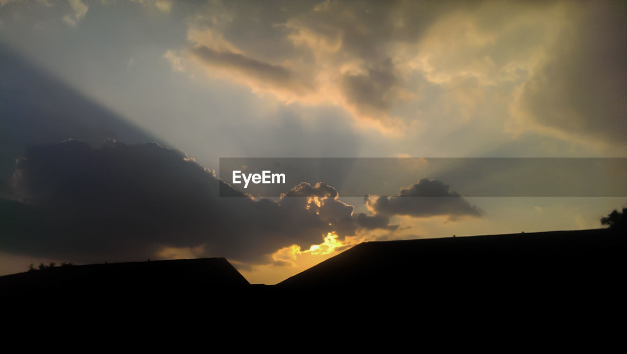 Low angle view of silhouette building against sky during sunset