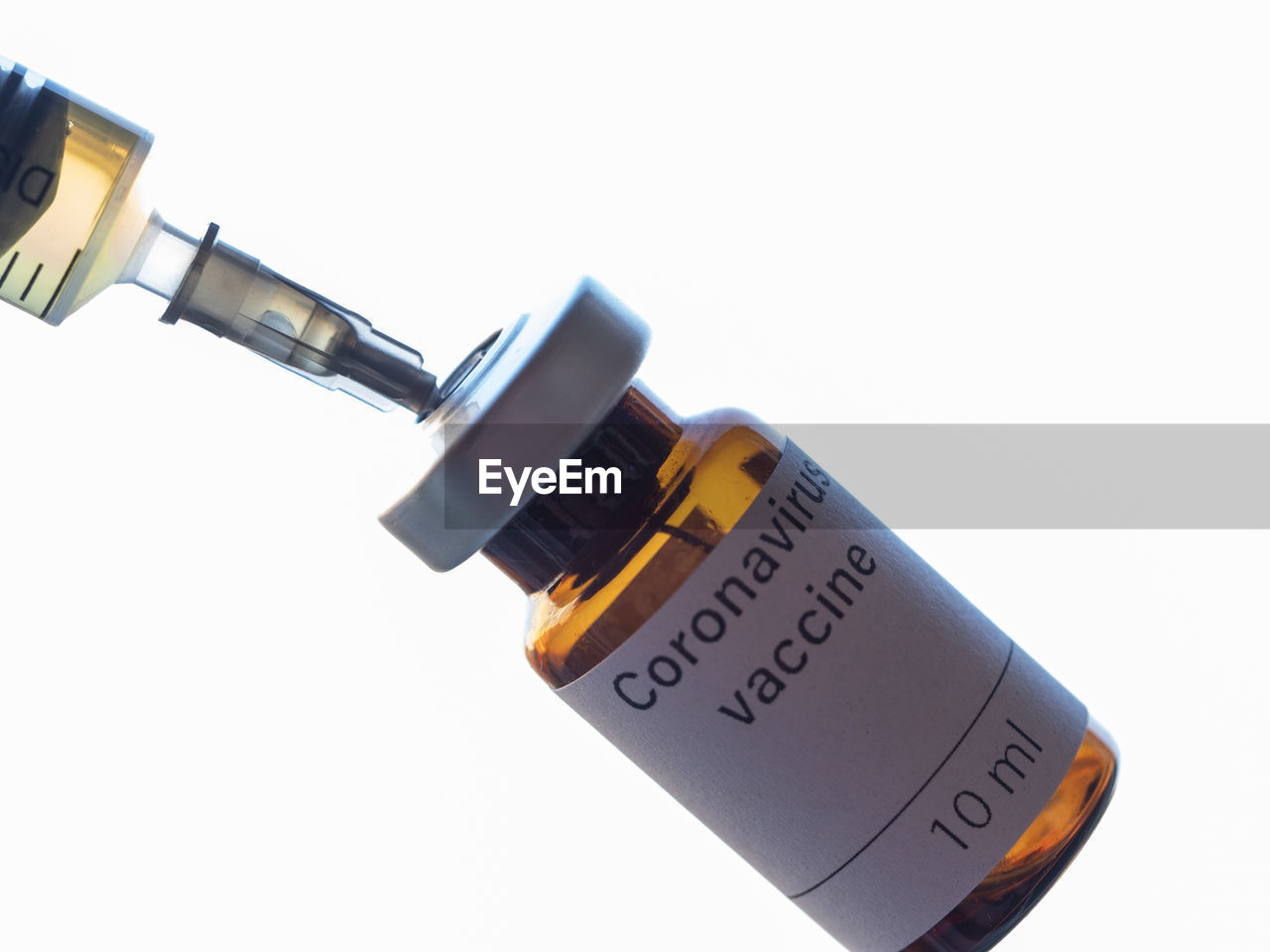 The photo illustration shows vial labeled coronavirus vaccine and syringe.