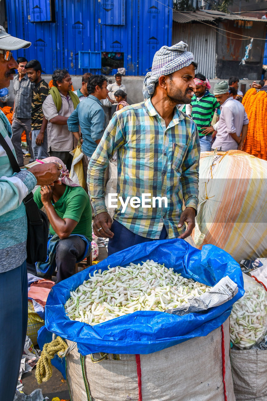 GROUP OF PEOPLE WORKING IN MARKET