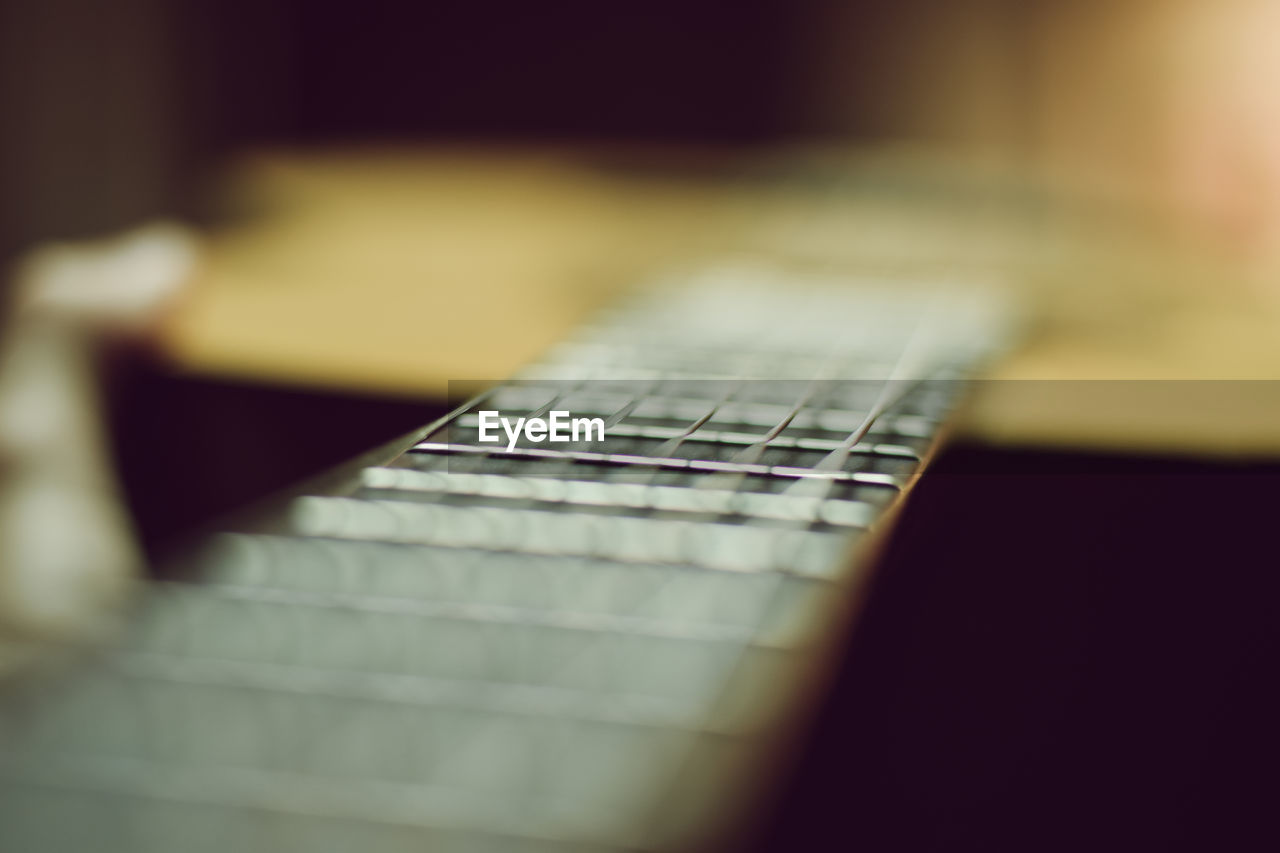 Close-up of guitar on table