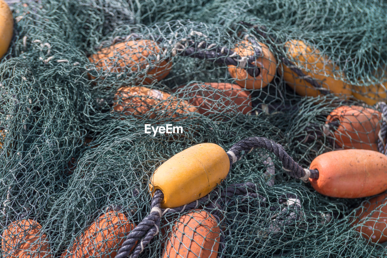 Full frame shot of fishing net and buoys