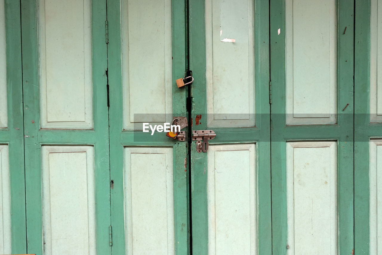 CLOSE-UP OF CLOSED GREEN DOOR