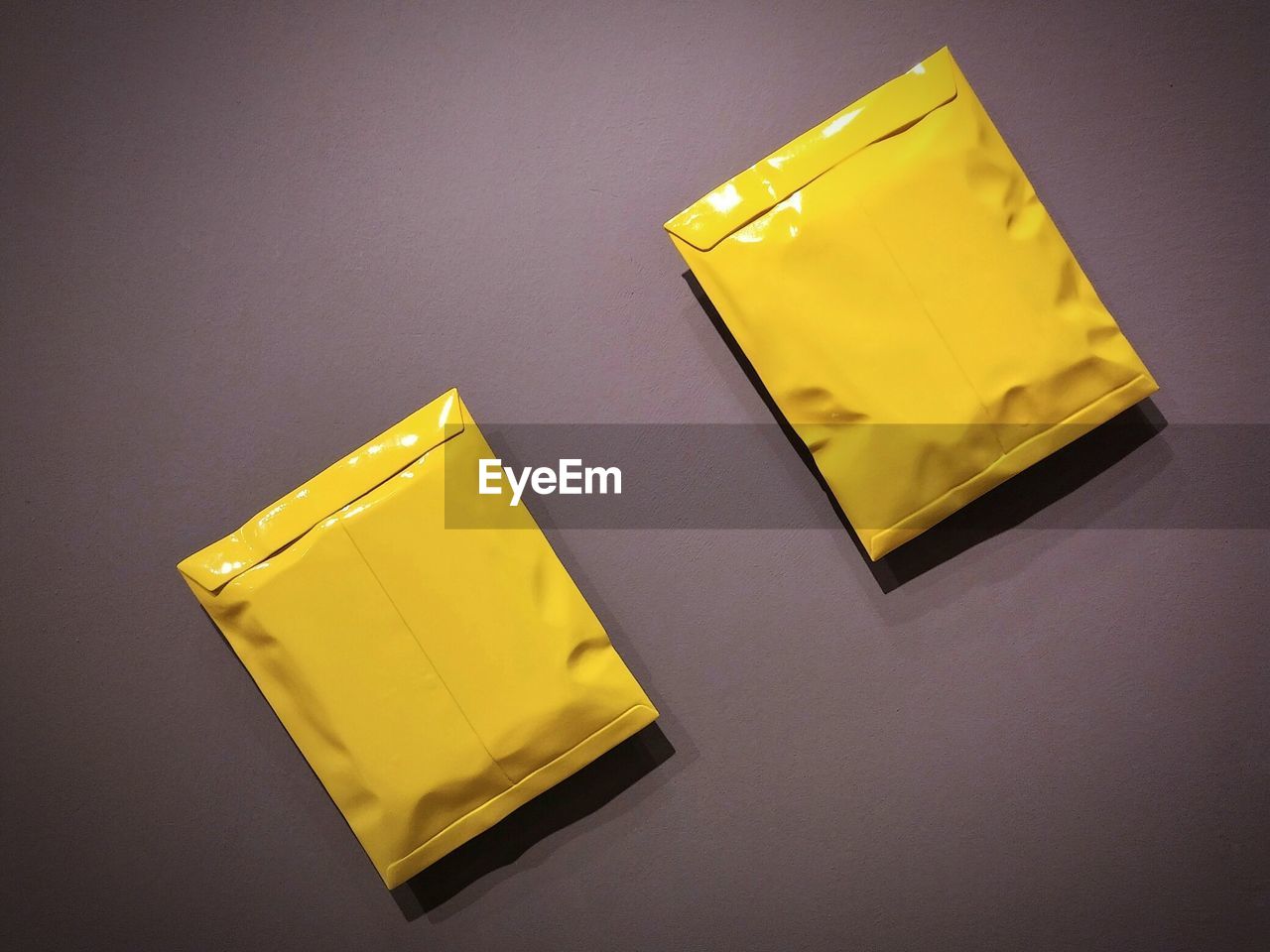 Directly above shot of closed yellow envelopes