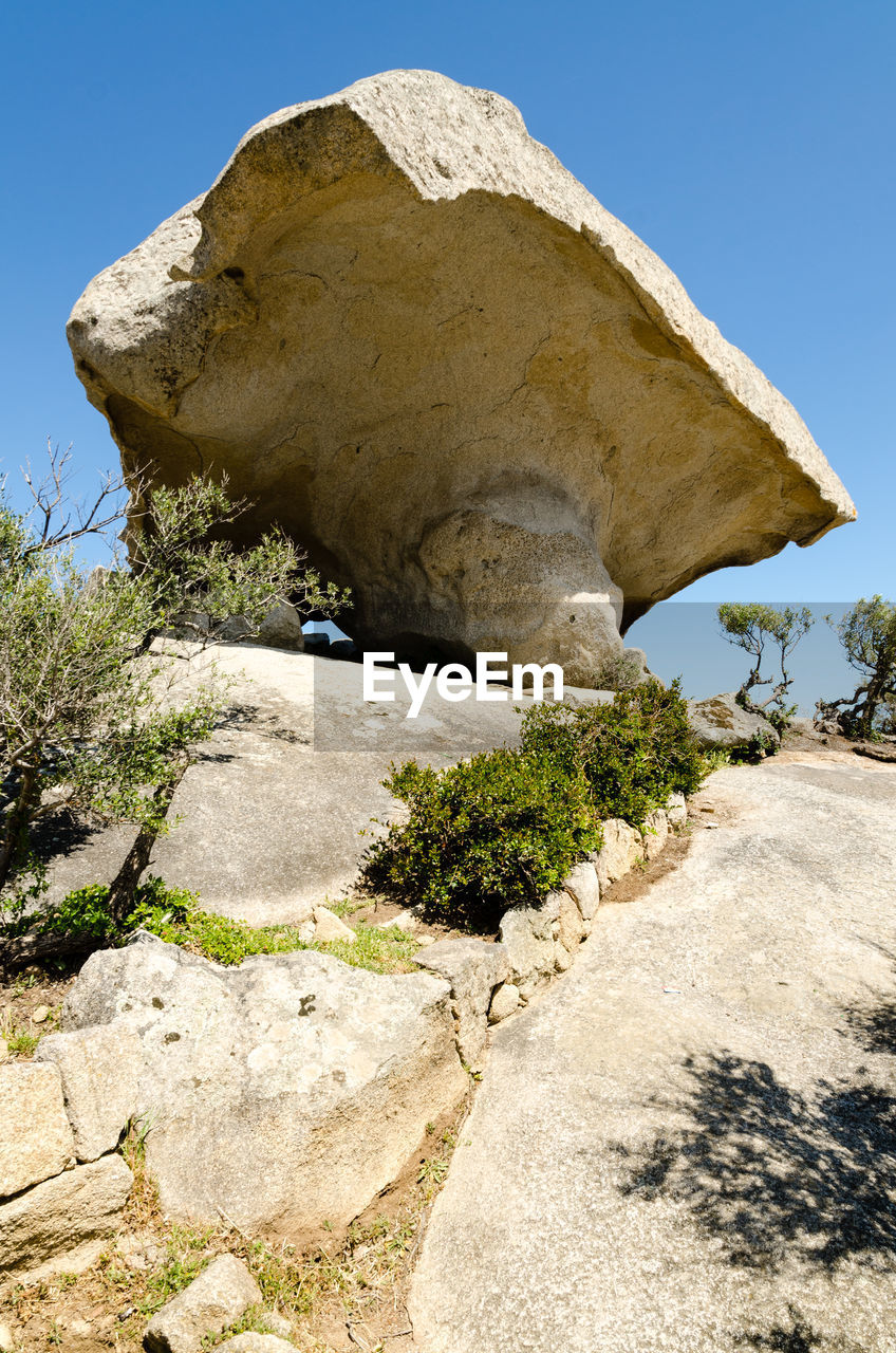 LOW ANGLE VIEW OF ROCK FORMATION AGAINST SKY